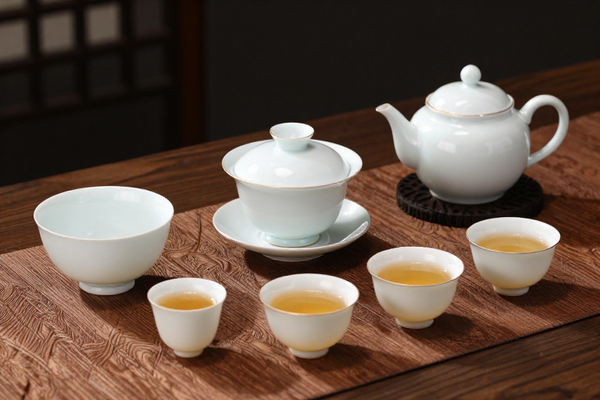 Chinese tea ceremony set, elegant porcelain, traditional teaware on silk
