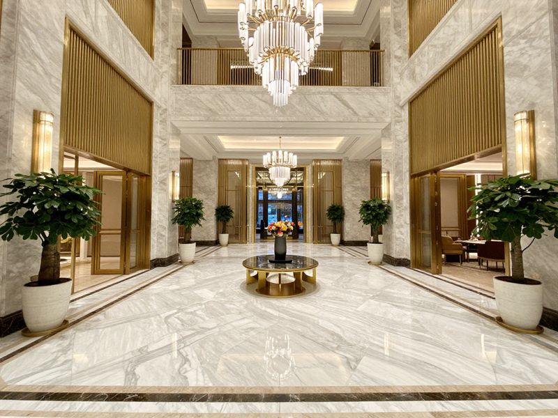 Luxury hotel lobby interior design, marble floors, golden accents